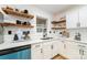 Bright kitchen with white cabinets, black hardware, stainless sink and light blue dishwasher at 1498 Oakridge Farm Hwy, Mooresville, NC 28115
