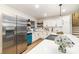 Bright kitchen features white cabinets, stainless steel appliances, and open wood shelving at 1498 Oakridge Farm Hwy, Mooresville, NC 28115