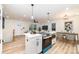Open-concept kitchen with island, stainless steel appliances, and adjacent dining area at 1498 Oakridge Farm Hwy, Mooresville, NC 28115
