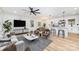 Open-concept living room with hardwood floors, neutral decor, and a modern ceiling fan at 1498 Oakridge Farm Hwy, Mooresville, NC 28115