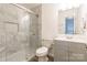 Modern bathroom featuring a glass shower with marble tile and a vanity with gray cabinets at 1515 Kingdom Way, Indian Land, SC 29707