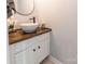 Modern half bath featuring white vessel sink, wood countertop, and decorative geometric wallpaper at 1515 Kingdom Way, Indian Land, SC 29707