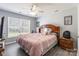 Comfortable bedroom featuring a ceiling fan, window with blinds, and stylish wooden furniture at 1515 Kingdom Way, Indian Land, SC 29707
