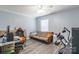 Bedroom with hardwood style flooring featuring a futon couch and an entertainment center at 1515 Kingdom Way, Indian Land, SC 29707