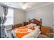 Cozy bedroom featuring a wooden bed frame, Tennessee Volunteers blanket, and neutral walls at 1515 Kingdom Way, Indian Land, SC 29707