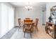 Bright dining area with a wood table, chandelier, and view of the backyard at 1515 Kingdom Way, Indian Land, SC 29707