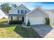 Charming two-story home with light gray siding, attached garage and manicured lawn at 1515 Kingdom Way, Indian Land, SC 29707