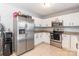 Well-lit kitchen with stainless steel appliances and white cabinets at 1515 Kingdom Way, Indian Land, SC 29707