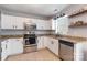 Modern kitchen with white cabinets, granite countertops, and stainless steel appliances at 1515 Kingdom Way, Indian Land, SC 29707