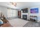 Comfortable living room with a fireplace, television and large window at 1515 Kingdom Way, Indian Land, SC 29707