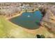 Aerial view of the community pond with a fountain, surrounded by trees and green space at 1515 Kingdom Way, Indian Land, SC 29707