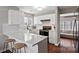 Contemporary kitchen with white cabinets, marble countertops, and bar seating at 17430 Tuscany Ln, Cornelius, NC 28031