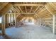 Unfinished attic space ready for customization with exposed wooden beams and plywood flooring at 175 Riley'S Dr, Salisbury, NC 28146