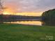 Scenic backyard with a lake view offers a tranquil and picturesque setting at sunset at 175 Riley'S Dr, Salisbury, NC 28146