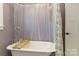 Charming bathroom features a soaking tub, purple walls, and decorative shower curtain at 175 Riley'S Dr, Salisbury, NC 28146