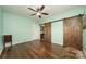 Bedroom featuring wood floors and barn door closet at 175 Riley'S Dr, Salisbury, NC 28146