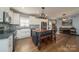 Bright kitchen featuring an island with seating, white cabinets, and modern appliances at 175 Riley'S Dr, Salisbury, NC 28146