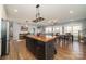 Open-concept kitchen with central island adjoining living and dining areas at 175 Riley'S Dr, Salisbury, NC 28146