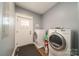 Efficient laundry room with washer, dryer, door to the outside, and gray walls at 175 Riley'S Dr, Salisbury, NC 28146