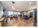 Open-concept living area with hardwood floors seamlessly connects to kitchen at 175 Riley'S Dr, Salisbury, NC 28146