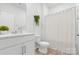 Bright bathroom featuring a vanity with sink and a shower/tub with curtain at 1949 Vanderlyn St, Monroe, NC 28112