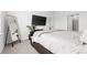 Well-lit bedroom featuring a large bed, accent mirror, and wall-mounted television for entertainment at 1949 Vanderlyn St, Monroe, NC 28112