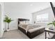 Relaxing bedroom featuring a large bed with upholstered bench, and a plant for added coziness at 1949 Vanderlyn St, Monroe, NC 28112
