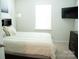 Bedroom featuring carpet, a queen bed, tv, neutral walls, and ample lighting at 1949 Vanderlyn St, Monroe, NC 28112