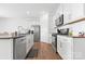 Well appointed kitchen featuring white cabinets, granite countertops, and stainless steel appliances at 1949 Vanderlyn St, Monroe, NC 28112
