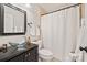 This bathroom features a glass vessel sink, black accents, and neutral wall colors at 201 Oak Creek Dr, Charlotte, NC 28270