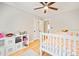 Bright bedroom with hardwood floors, white furniture, and a ceiling fan at 201 Oak Creek Dr, Charlotte, NC 28270