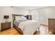 Well-lit bedroom with hardwood floors, a plush bed, and a large window at 201 Oak Creek Dr, Charlotte, NC 28270