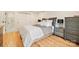 Bright bedroom featuring hardwood floors, a comfortable bed, and ample storage at 201 Oak Creek Dr, Charlotte, NC 28270