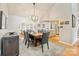 Open dining area with modern chandelier, hardwood floors, and views of the kitchen at 201 Oak Creek Dr, Charlotte, NC 28270