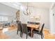 Open dining area with modern chandelier, hardwood floors, and view of the living room at 201 Oak Creek Dr, Charlotte, NC 28270