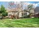 Backyard view of home, with a brick path and a lush lawn at 201 Oak Creek Dr, Charlotte, NC 28270