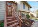 Home's front entrance has a modern door, stone accents, and landscaped stairs at 201 Oak Creek Dr, Charlotte, NC 28270