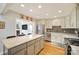 Well-lit kitchen with stainless steel appliances, granite countertops, and ample cabinet space; open to living area at 201 Oak Creek Dr, Charlotte, NC 28270