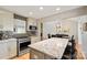 Spacious kitchen with granite countertops, stainless appliances, breakfast bar, seamlessly connected to the dining area at 201 Oak Creek Dr, Charlotte, NC 28270
