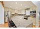 Bright kitchen featuring stainless steel appliances, granite countertops, gray subway tile backsplash, and breakfast bar seating at 201 Oak Creek Dr, Charlotte, NC 28270