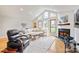 Bright living room with vaulted ceiling, large windows, fireplace, and open layout, creating a welcoming space at 201 Oak Creek Dr, Charlotte, NC 28270