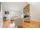 Cozy living room with stone fireplace, comfortable seating, and plenty of natural light at 201 Oak Creek Dr, Charlotte, NC 28270