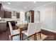 Stylish dining area with dark wood cabinetry and modern lighting complements the open-concept kitchen design at 2018 Kensley Dr, Waxhaw, NC 28173