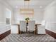 Formal dining room with hardwood floors, a stylish light fixture, and ample natural light at 2018 Kensley Dr, Waxhaw, NC 28173