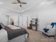 This main bedroom features a tray ceiling, a ceiling fan, and carpet at 2018 Kensley Dr, Waxhaw, NC 28173