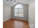 Bedroom features hardwood floors, vaulted ceilings, and neutral paint at 2024 Hedgelawn Dr, Charlotte, NC 28262