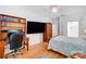 Modern bedroom with a built-in workstation, mounted TV, and access to the bathroom at 2036 Hudson Ln, Fort Mill, SC 29707