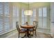 Bright dining area featuring natural light from shuttered windows and a round table with chairs at 2036 Hudson Ln, Fort Mill, SC 29707