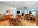 Open-concept dining room with wood floors, traditional furniture, and bright lighting at 2036 Hudson Ln, Fort Mill, SC 29707