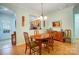Traditional dining room featuring wood floors, decorative art and view to kitchen area at 2036 Hudson Ln, Fort Mill, SC 29707